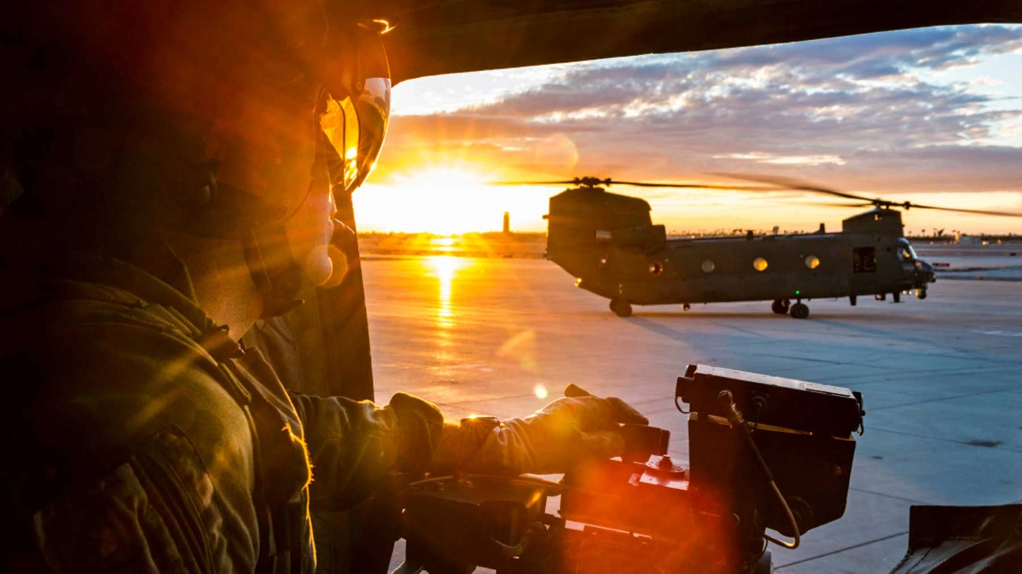 Soldier in army plane at sunset