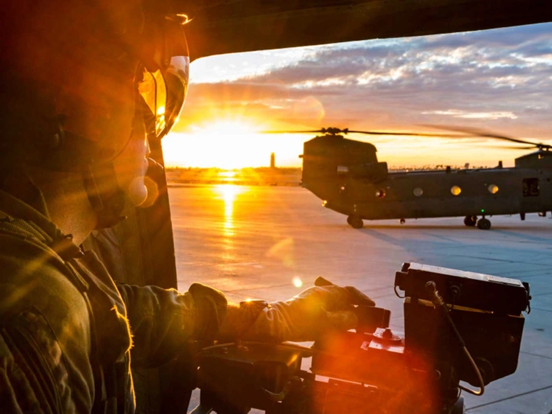 Soldier in army plane at sunset