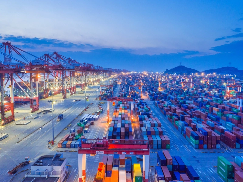 Docklands storage area with ship containers and dark blue night sky