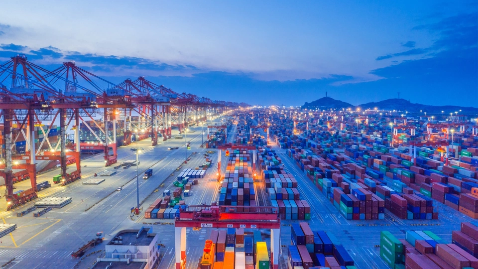 Docklands storage area with ship containers and dark blue night sky