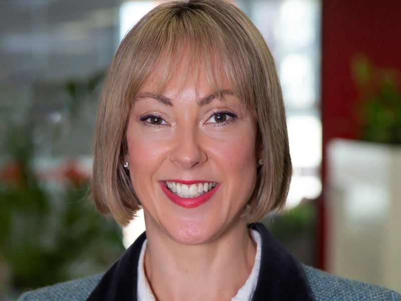 Portrait of Alana Newbrook, Head of Infrastructure, Australia and New Zealand, smiling in plant based office