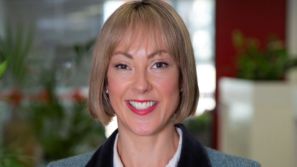 Portrait of Alana Newbrook, Head of Infrastructure, Australia and New Zealand, smiling in plant based office