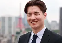 Portrait of Jin Parisien, Data Centre Services Lead, Asia, standing outside with city landscape in the background, smiling.