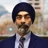 Portrait of Gurjot Bhatia, Managing director, South Asia, Standing outside featuring an urban cityscape with tall buildings and a mix of architectural styles. The scene includes some trees with autumn foliage, adding a touch of color.