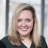 Portrait of Laura Stevens, Global Senior External Communications Manager, in a glass office