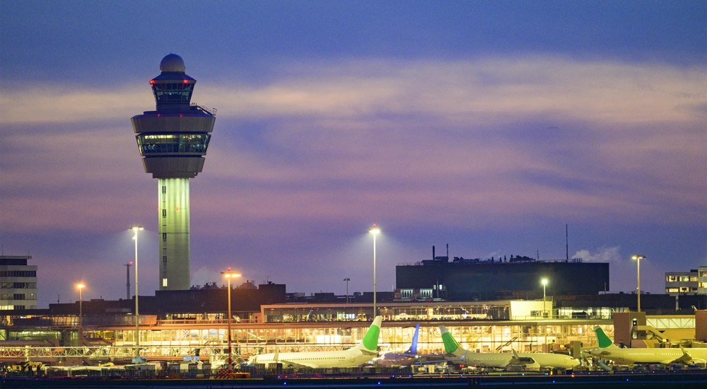 Schipol Airport airfield, terminal and air traffic control tower illuminated at dusk, Amsterdam, The Netherlands