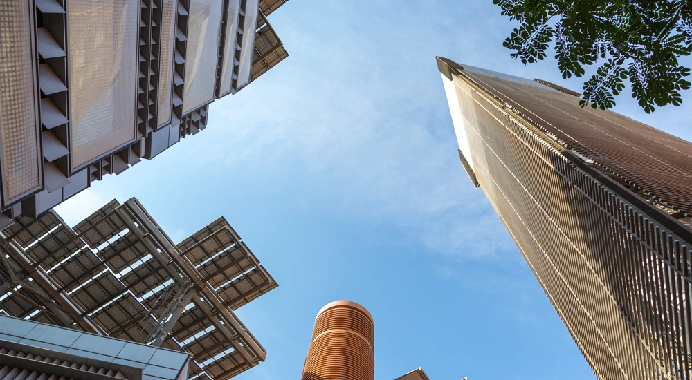 Upwards view of skyscraper buildings and blue sky