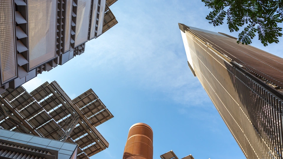 Upwards view of skyscraper buildings and blue sky