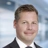 Portrait of Gavin Steele Director, Global Head of Aviation standing in blurred office background.