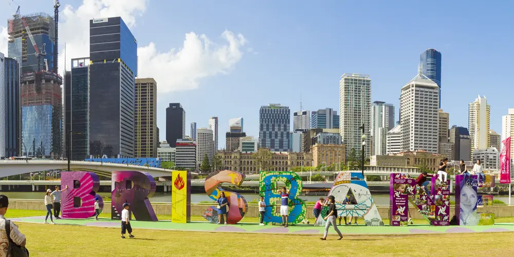 People enjoying colorful Brisbane sign at South Bank, Queensland, Australia.