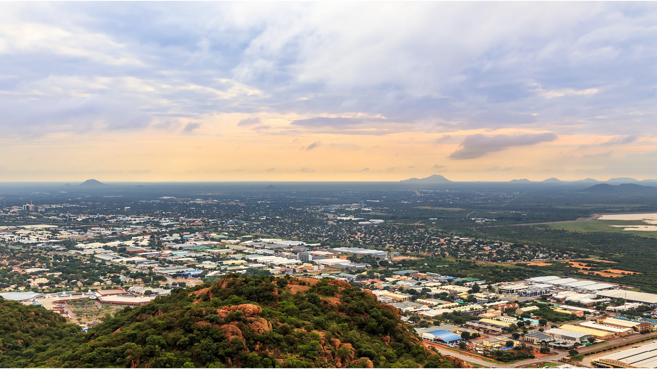 Landscape view with mountains and buildings at sunset