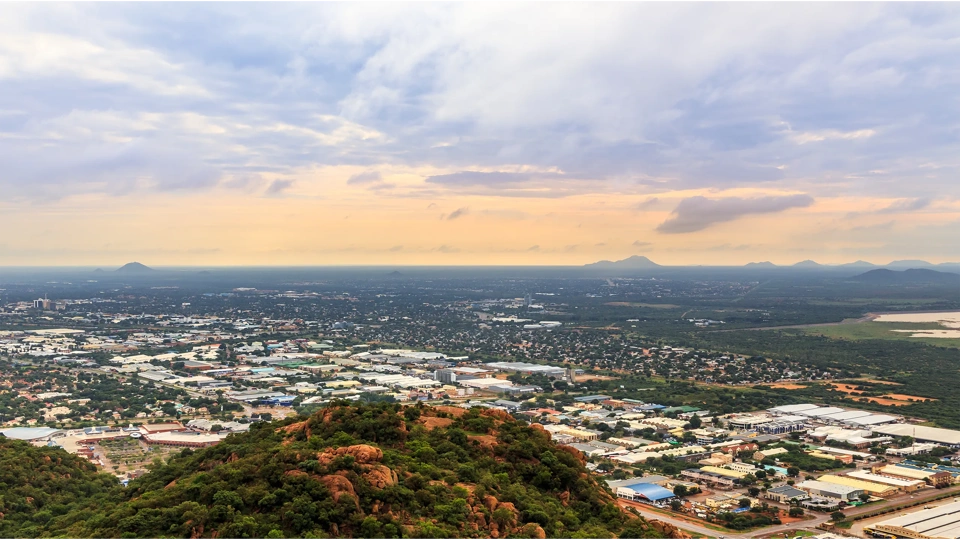 Landscape view with mountains and buildings at sunset