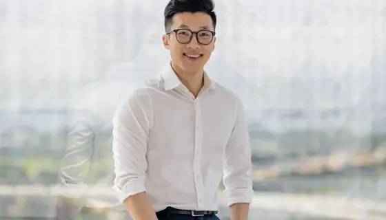 Portrait of Babalwa Damane, Director, Mining and Metals, South Africa sitting in office space in pink shirt smiling.