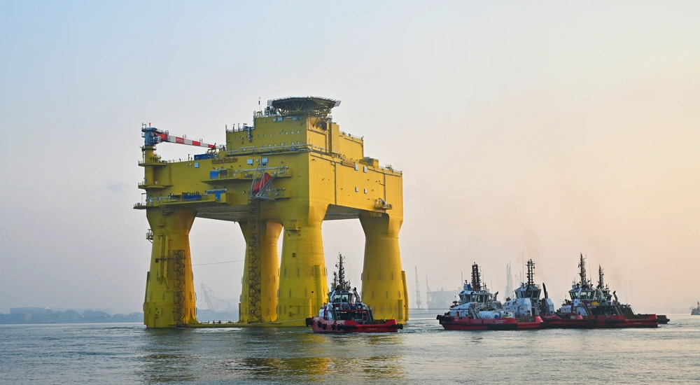 The DolWin epsilon converter station and tugboats at sea