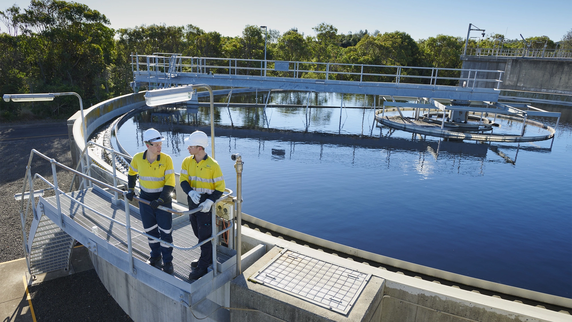 Water infrastructure and two men wearing high vis