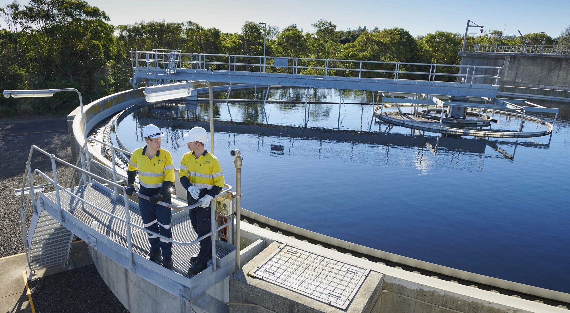 Water infrastructure and two men wearing high vis
