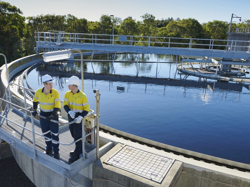 Water infrastructure and two men wearing high vis