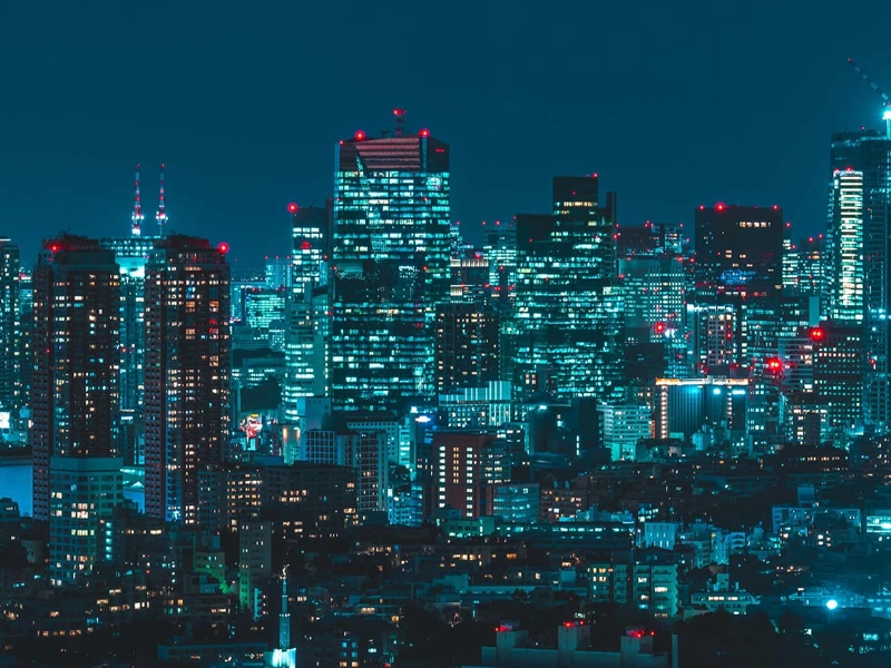 Japan skyscrapers lit up in the dark