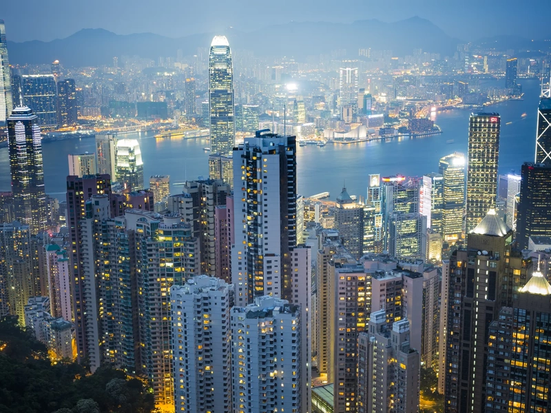 skyscraper on two side of Victoria Harbour of Hong Kong. View from the Peak at night.