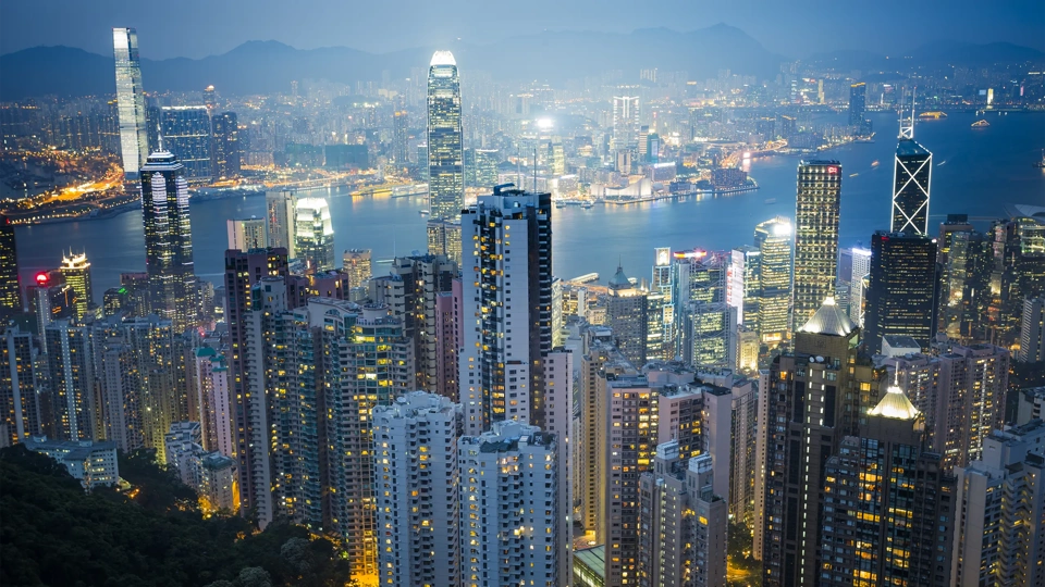 skyscraper on two side of Victoria Harbour of Hong Kong. View from the Peak at night.