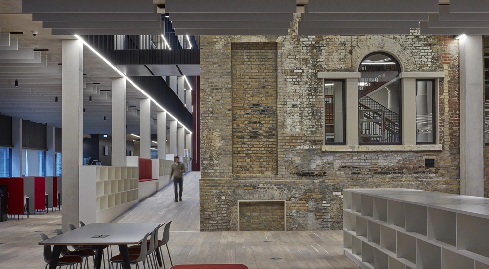Interior shot of Tower Hamlets Town Hall with person walking down corridor.