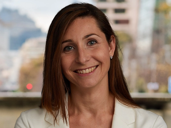 Portrait of Cinzia Gai, Senior Business Generation Manager, Germany, smiling in white blazer