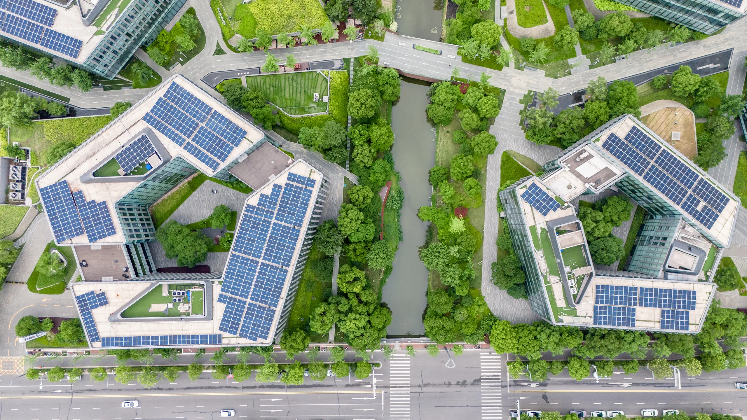 Aerial Top view of green rooftop architecture in eco-conscious cityscape, showing sustainable skyscrapers with trees, landscaped terraces, and climate-focused design promoting CO2 reduction and ESG goals.