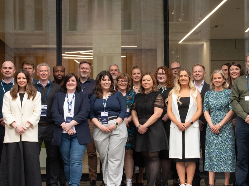 Turner & Townsend Aberdeen team outside city centre office smiling.