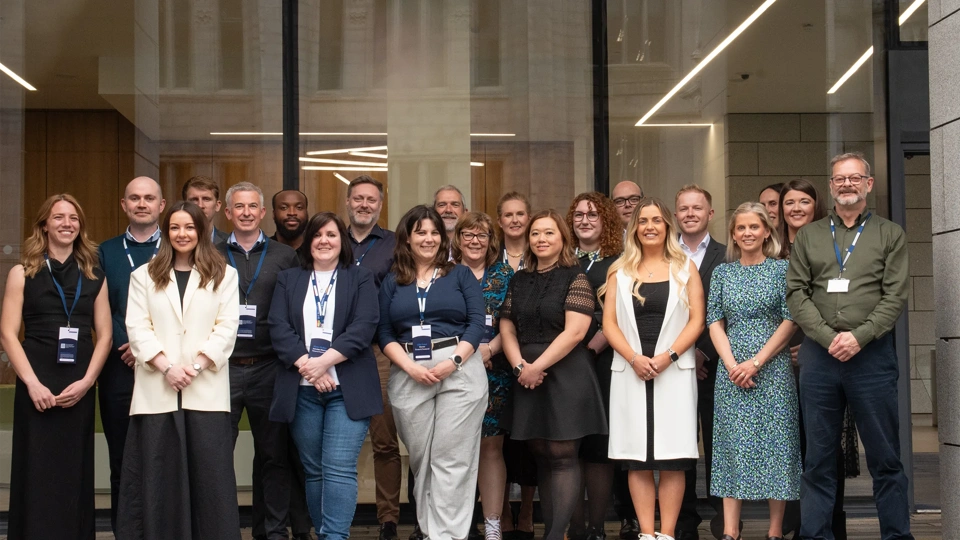 Turner & Townsend Aberdeen team outside city centre office smiling.