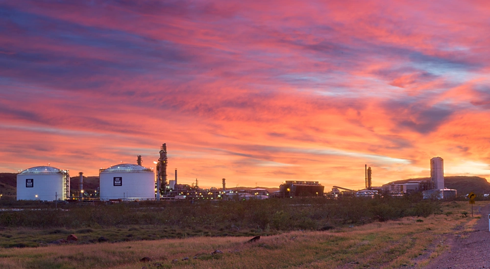 Picture of two tanks against pink, blue and orange sunset