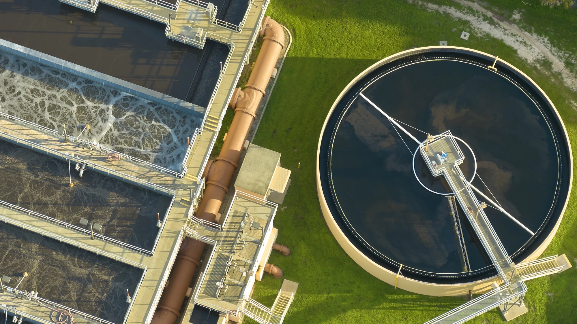 Aerial view of modern water cleaning facility at urban wastewater treatment plant. Purification process of removing undesirable chemicals, suspended solids and gases from contaminated liquid.