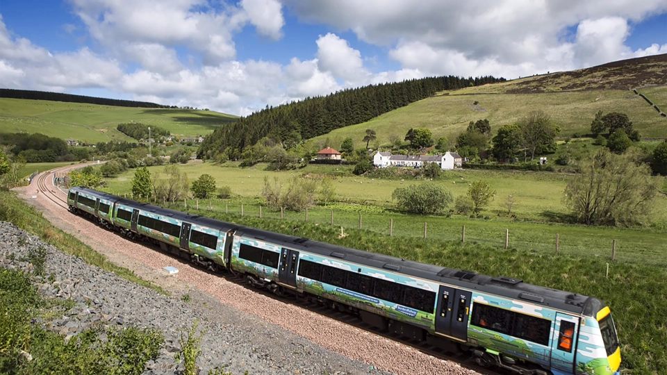 Passanger train passing through british countryside