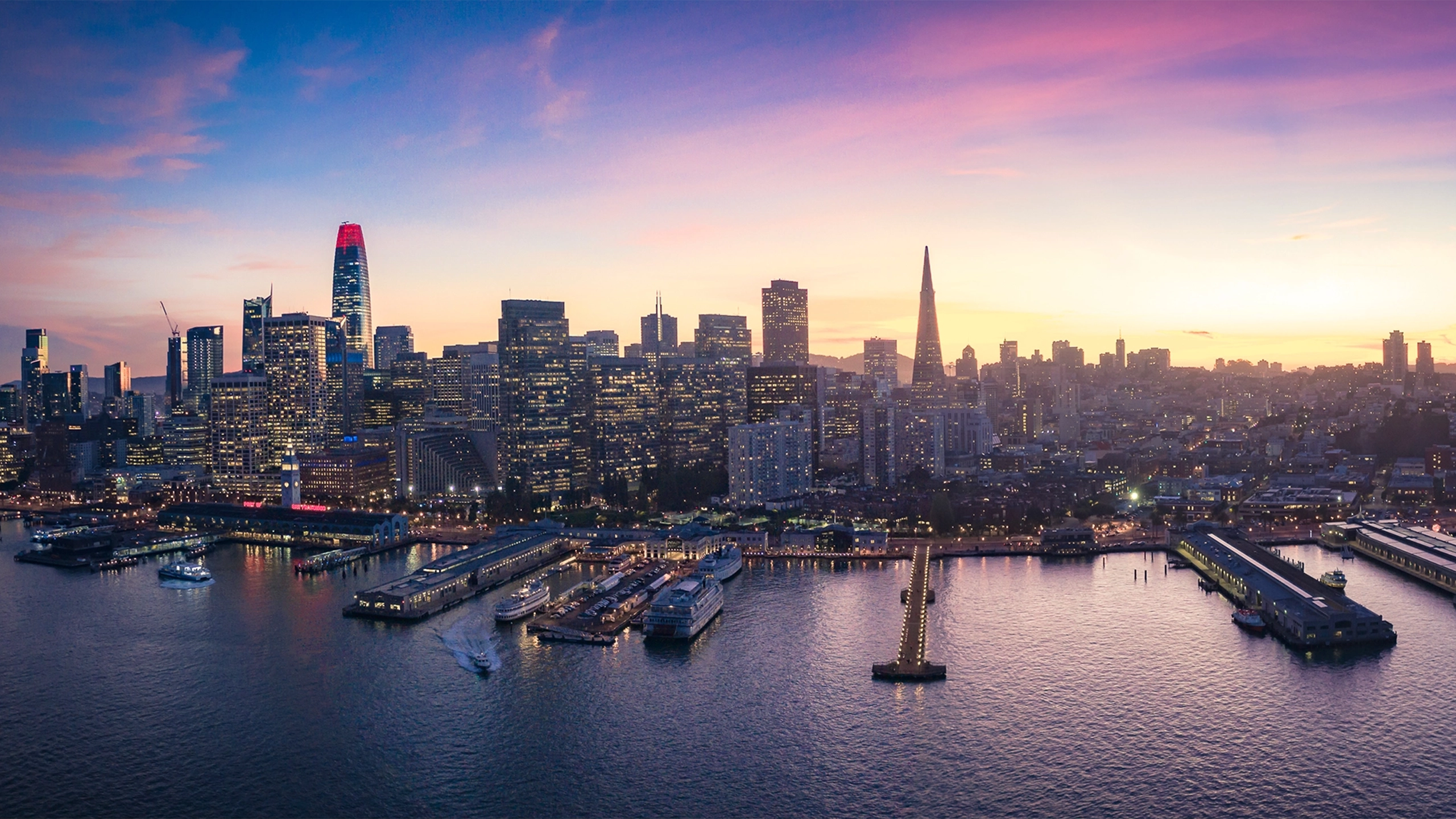 Skyline of marina with boats and city skyscrapers with lights