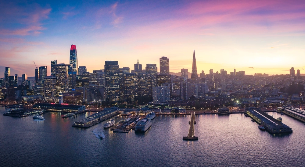 Skyline of marina with boats and city skyscrapers with lights