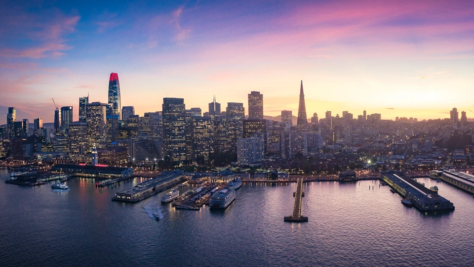 Skyline of marina with boats and city skyscrapers with lights