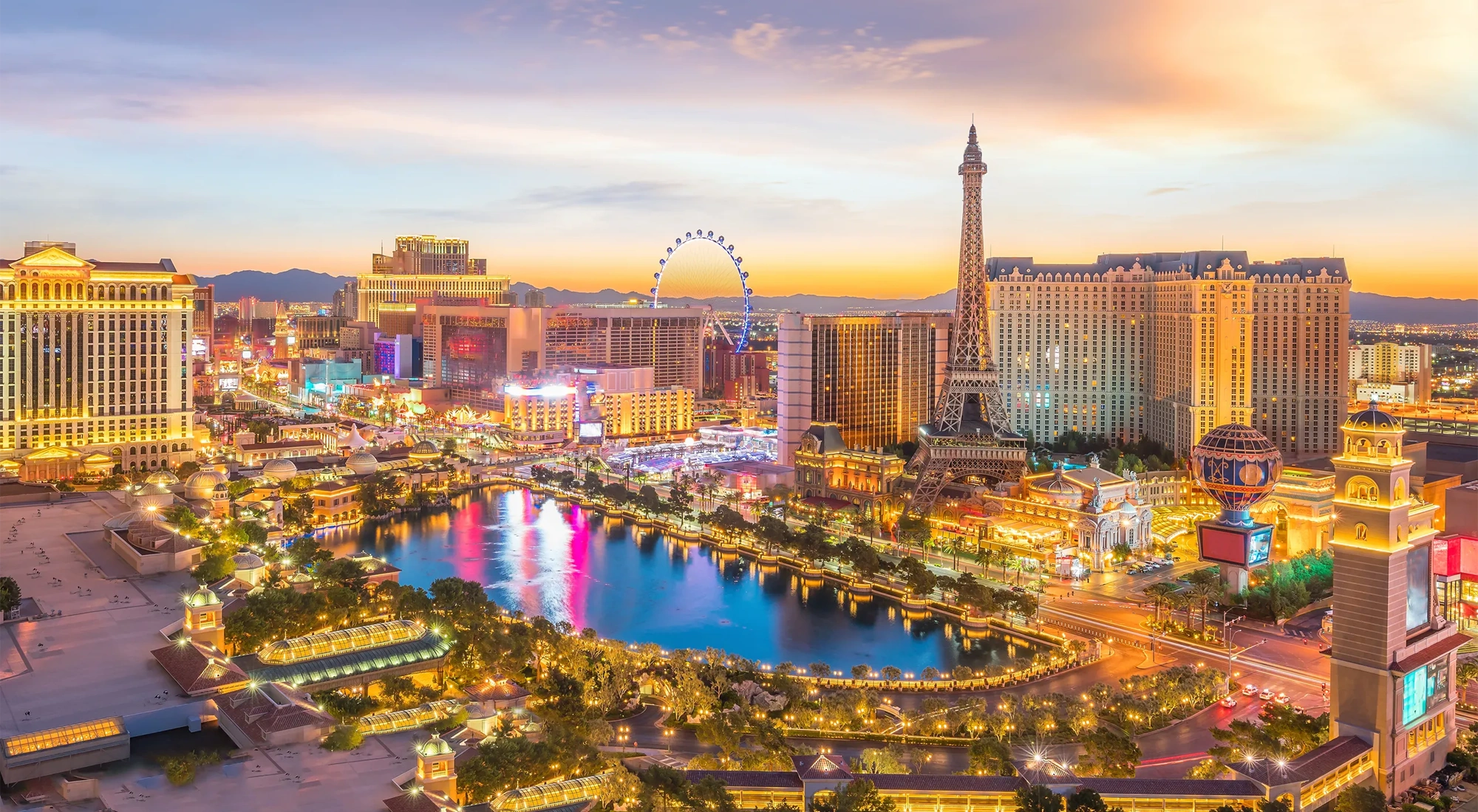 Landscape view of Las vegas during sunset, wth all the lights on the building lit up.