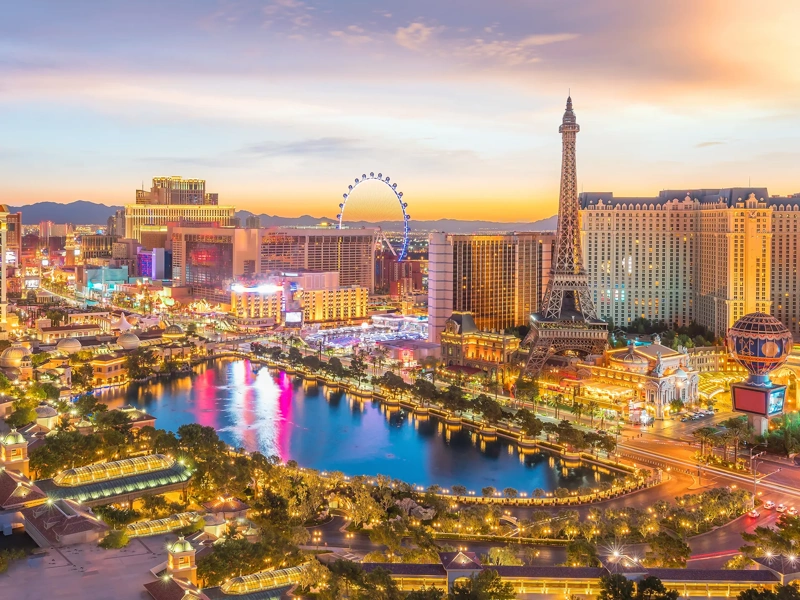 Landscape view of Las vegas during sunset, wth all the lights on the building lit up.