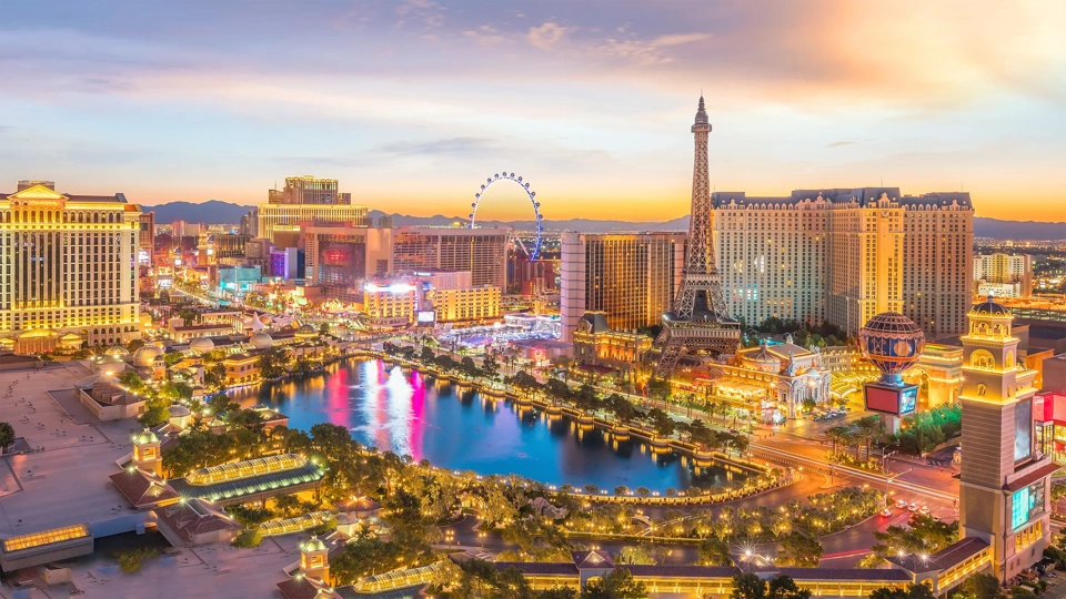 Landscape view of Las vegas during sunset, wth all the lights on the building lit up.