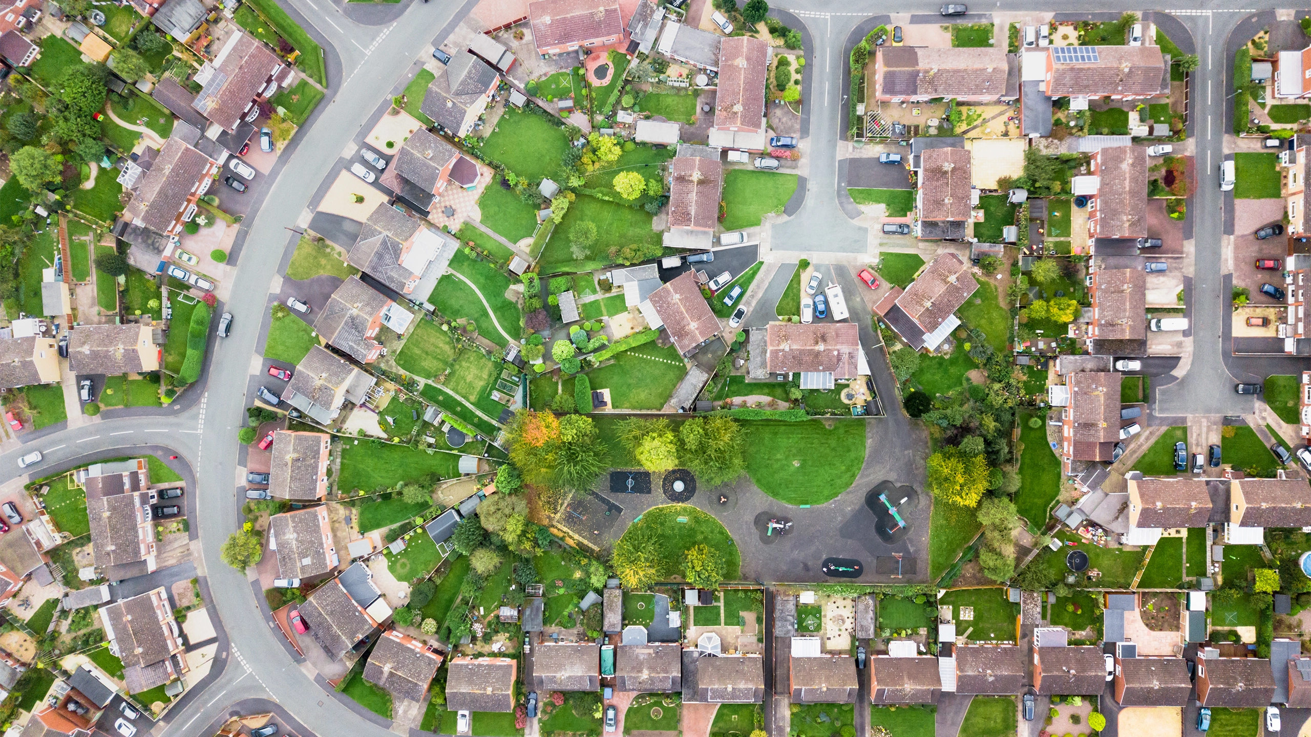 Aerial view of houses in a village, showing street layout and gardens