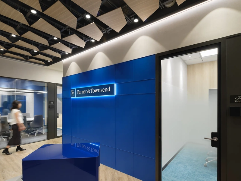 Turner & Townsend Taiwan office reception, with blue background and logo.