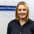 Portrait of Steph Marahall, Managing Director, UK Cost Management, standing in office in front of Turner & Townsend sign