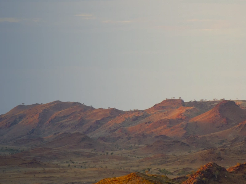 Brown mountains against blue / grey sky