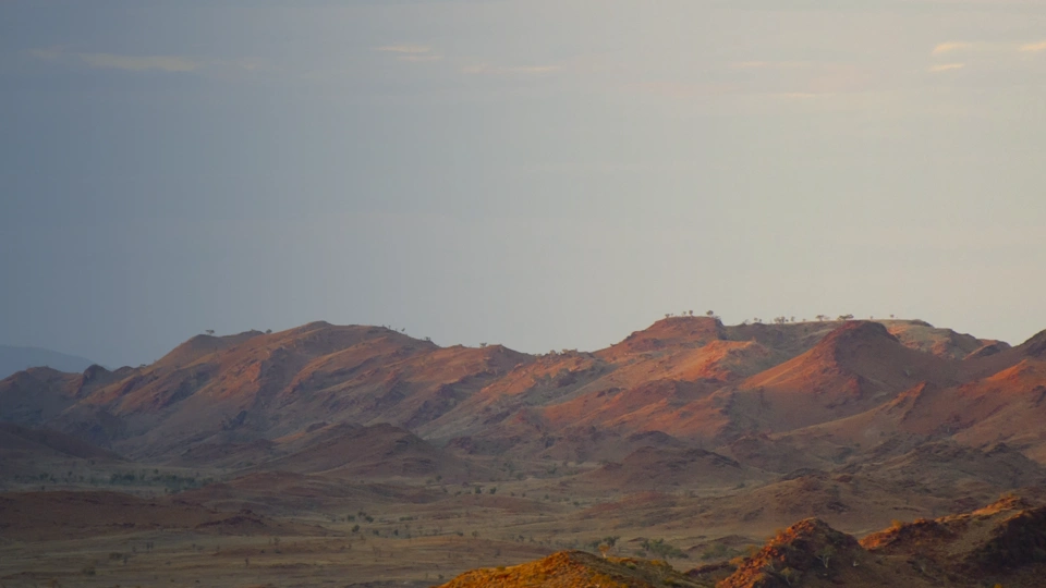Brown mountains against blue / grey sky