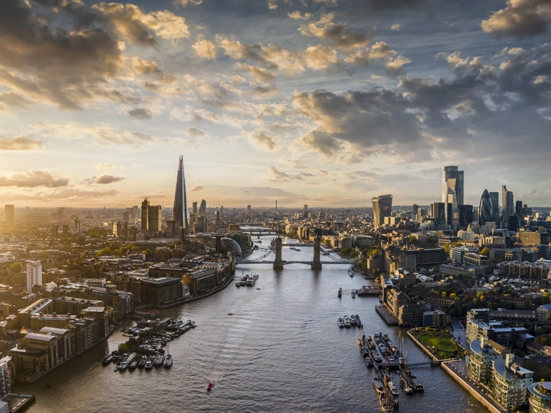View of London landmarks such as the London bridge and River Thames with the sun beaming down on the view of London