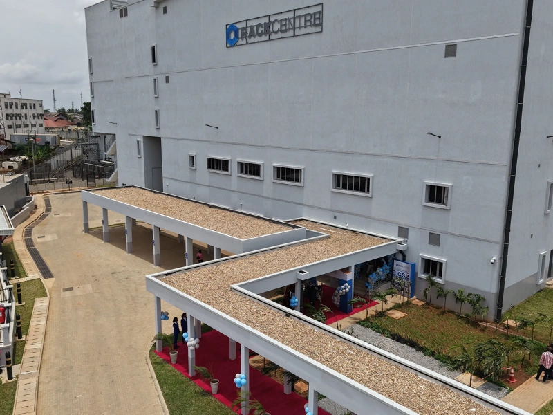 Ezteror view of Rack Centre, large industrial building with a covered walkway and people walking nearby.