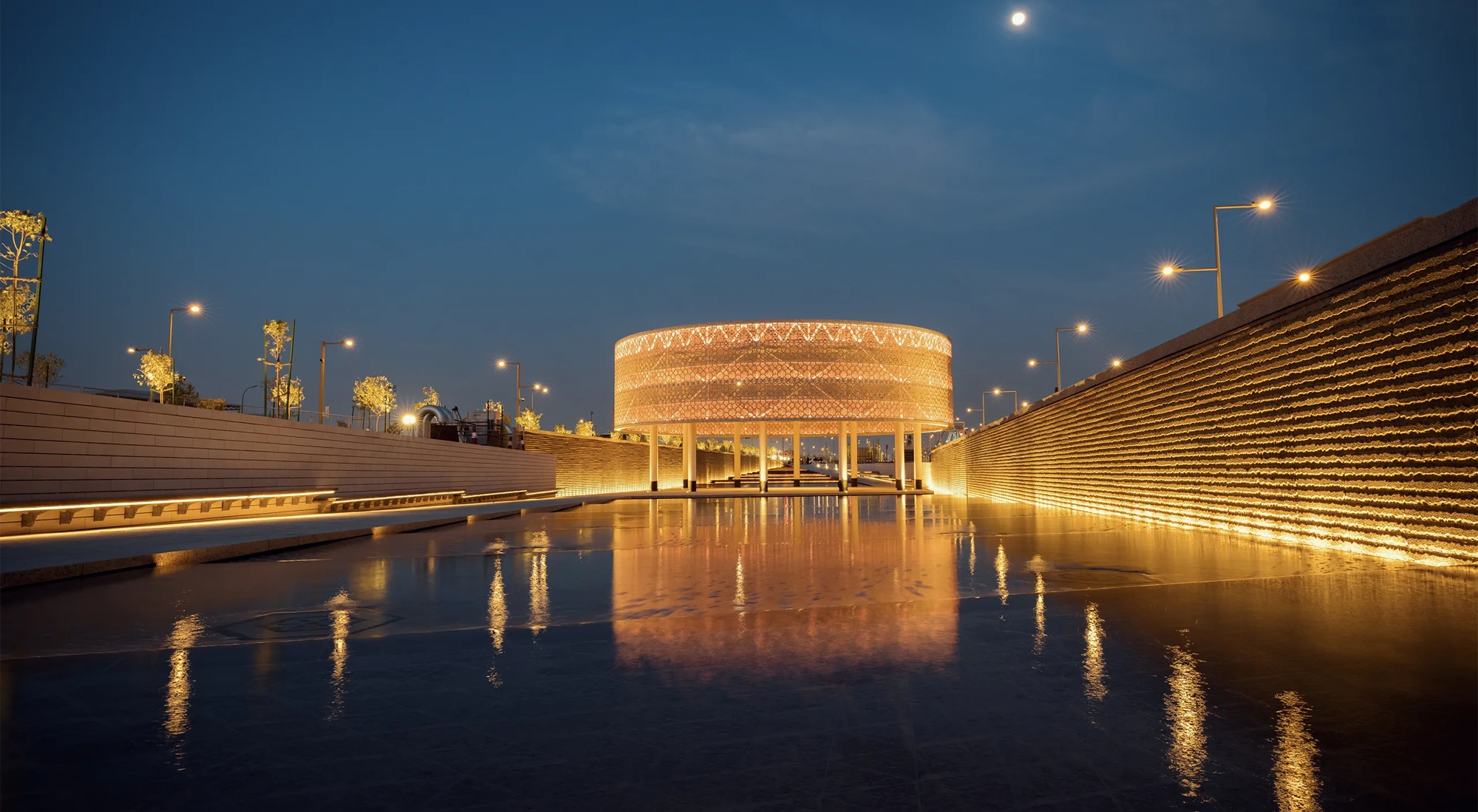 Sports Boulevard at night, illuminating golden colour with wet pathway, Kingdom of Saudi Arabia