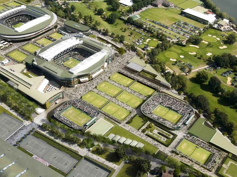 An aerial shot of Wimbledon tennis courts, including Centre Court and surrounding green areas.