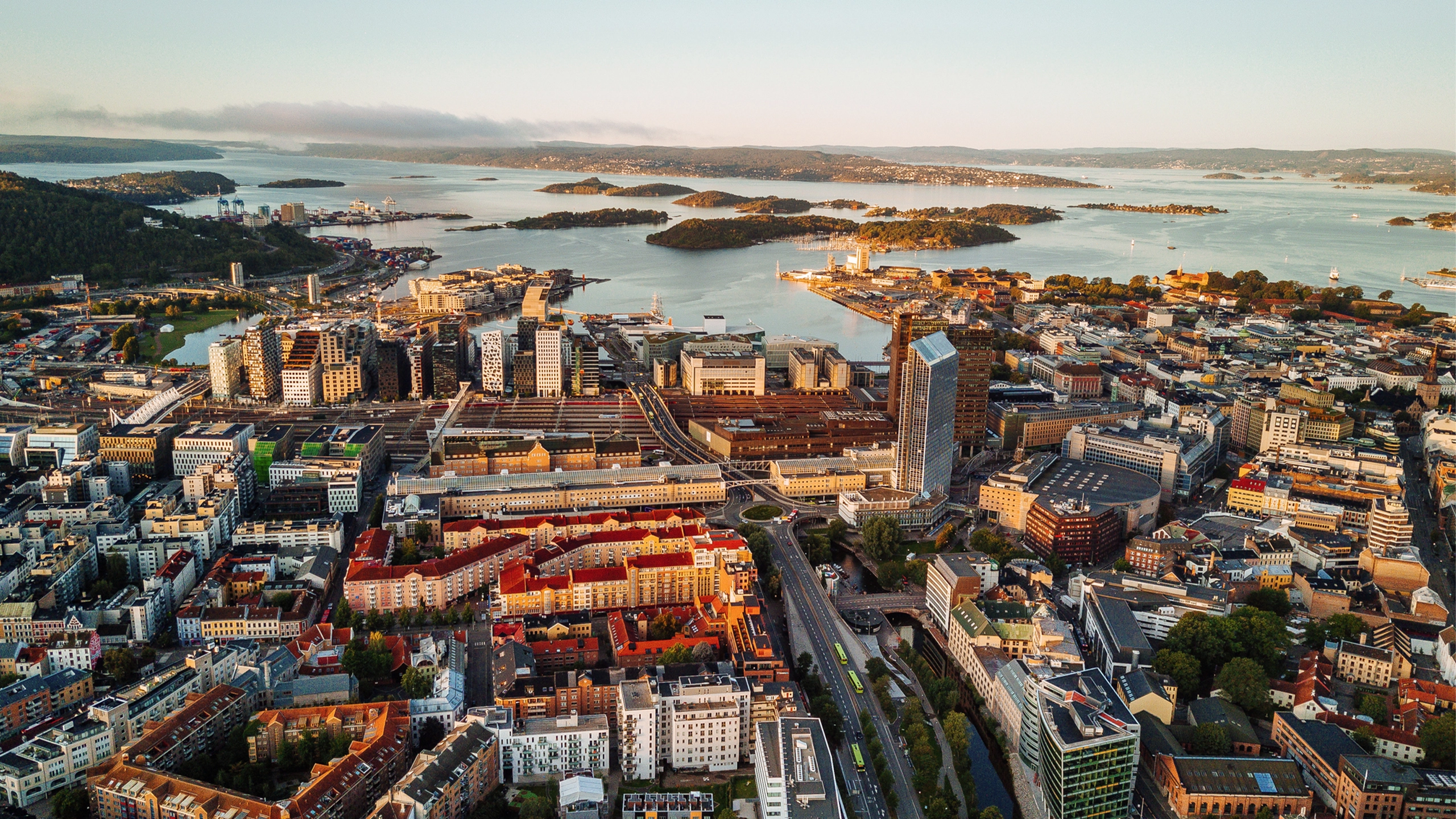 Oslo, Norway, Scandinavia. Beautiful 4K panoramic aerial video from flying drone to Oslo city center. Against the background of the mountains, North Sea and blue sky on a sunny summer day.