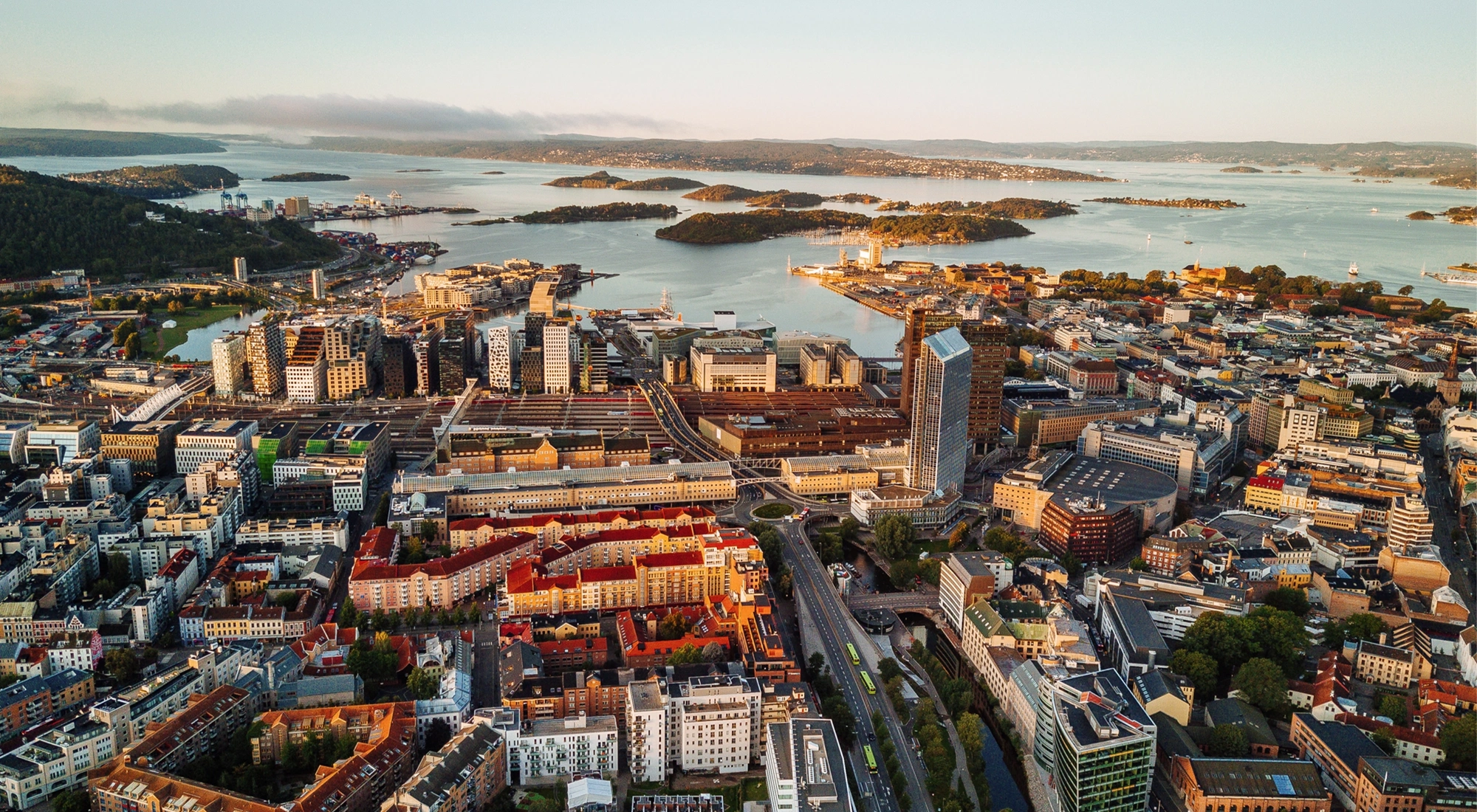 Oslo, Norway, Scandinavia. Beautiful 4K panoramic aerial video from flying drone to Oslo city center. Against the background of the mountains, North Sea and blue sky on a sunny summer day.