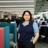 Portrait of Verriin Kaur, Global External Communications Manager, Standing in office against blue and orange chair.